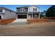 New two-story home featuring a two-car garage, gray siding, and a well-manicured front yard at 700 Deschutes Dr, Garner, NC 27529