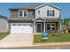 Charming two-story home boasts a pristine white garage door and beautifully maintained front yard at 700 Deschutes Dr, Garner, NC 27529