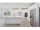 Modern kitchen with stainless steel appliances, white cabinetry, and a central island offering ample counter space at 700 Deschutes Dr, Garner, NC 27529