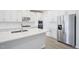 Well-appointed kitchen featuring stainless steel appliances, white cabinets, and island countertop seating and food prep at 700 Deschutes Dr, Garner, NC 27529