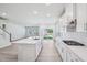 Modern, open-concept kitchen with stainless steel appliances, quartz countertops and views into the spacious living area at 700 Deschutes Dr, Garner, NC 27529