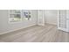 Sunlit study with stylish gray flooring and elegant french doors at 700 Deschutes Dr, Garner, NC 27529