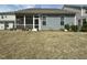 Exterior view of backyard with screen porch and blue siding on house at 7125 Crested Iris Pl, Durham, NC 27703