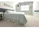 Well-lit bedroom featuring a bed with a patterned comforter at 7125 Crested Iris Pl, Durham, NC 27703