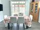 Cozy dining room with a large window, floral tablecloth, and classic wooden hutch at 7125 Crested Iris Pl, Durham, NC 27703