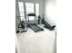 Bright room with carpeted floors and lots of exercise equipment at 7125 Crested Iris Pl, Durham, NC 27703