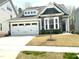 Charming home with a two-car garage and stone accents, featuring a well-maintained front yard at 7125 Crested Iris Pl, Durham, NC 27703