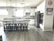 Modern kitchen with white cabinets, stainless steel appliances, and a breakfast bar at 7125 Crested Iris Pl, Durham, NC 27703