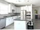 Contemporary kitchen with gray countertops, stainless steel appliances, and stylish pendant lighting at 7125 Crested Iris Pl, Durham, NC 27703