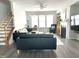 Bright living room with hardwood floors, a staircase, and comfortable furniture at 7125 Crested Iris Pl, Durham, NC 27703