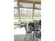 Cozy sunroom featuring an iron table and chairs with plants at 7125 Crested Iris Pl, Durham, NC 27703