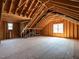 Spacious unfinished attic with exposed wood beams, ready for customization and ample natural light at 7312 Ridgeline Dr, Raleigh, NC 27613