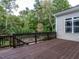 Wooden back deck overlooking a serene backyard with mature trees, offering a private and relaxing outdoor space at 7312 Ridgeline Dr, Raleigh, NC 27613