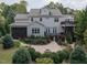 Expansive backyard featuring a stone fire pit, multiple decks, mature landscaping, and a screened porch at 7312 Ridgeline Dr, Raleigh, NC 27613