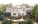Spacious backyard with multiple decks, a stone fire pit, mature landscaping, and a charming screened porch at 7312 Ridgeline Dr, Raleigh, NC 27613