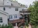 Multi-level backyard deck with an umbrella-covered dining area and outdoor seating, ideal for entertaining at 7312 Ridgeline Dr, Raleigh, NC 27613