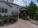 Landscaped backyard with a stone walkway leading to a multi-level deck, surrounded by lush greenery and mature trees at 7312 Ridgeline Dr, Raleigh, NC 27613