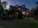 Exterior shot of the home featuring a backyard with a covered deck and lush landscaping at 7312 Ridgeline Dr, Raleigh, NC 27613