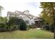 Expansive backyard featuring a two-story deck, lush landscaping, and mature trees perfect for outdoor activities at 7312 Ridgeline Dr, Raleigh, NC 27613
