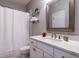 Bathroom with white cabinets, granite counters, large mirror, and shower with a curtain at 7312 Ridgeline Dr, Raleigh, NC 27613