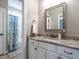 Bathroom with a granite countertop, white cabinets, a mirror, and a bathtub with shower at 7312 Ridgeline Dr, Raleigh, NC 27613
