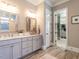 Chic bathroom with double vanity, designer mirrors and entry to large walk in closet at 7312 Ridgeline Dr, Raleigh, NC 27613