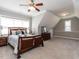 Cozy bedroom features a wooden bedframe, carpet flooring, and a window with natural light at 7312 Ridgeline Dr, Raleigh, NC 27613