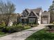 Spacious two-story home featuring a three-car garage, well-maintained lawn, and mature trees at 7312 Ridgeline Dr, Raleigh, NC 27613