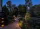 Outdoor stone fire pit with surrounding walkway and landscape lighting, perfect for relaxing evenings at 7312 Ridgeline Dr, Raleigh, NC 27613