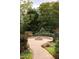 Outdoor stone fire pit with a surrounding patio, perfect for entertaining friends and Gathering outdoors at 7312 Ridgeline Dr, Raleigh, NC 27613