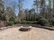 Outdoor stone fire pit with a surrounding patio, perfect for entertaining friends and Gathering outdoors at 7312 Ridgeline Dr, Raleigh, NC 27613