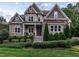Charming two-story home with stone accents, manicured landscaping, and inviting front porch at 7312 Ridgeline Dr, Raleigh, NC 27613