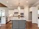 A kitchen showcases granite countertops, white cabinets, stainless steel appliances, and hardwood floors at 7312 Ridgeline Dr, Raleigh, NC 27613