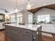 A kitchen showcases granite countertops, white cabinets, stainless steel appliances, hardwood floors, and vaulted ceilings at 7312 Ridgeline Dr, Raleigh, NC 27613