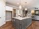 A kitchen features granite countertops, white cabinets, stainless steel appliances, hardwood floors, and an open concept at 7312 Ridgeline Dr, Raleigh, NC 27613
