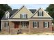 Charming brick home featuring a classic design with a red front door and black shutters at 801 Emmett Ct, Spring Hope, NC 27882