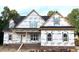New construction home exterior with brick foundation and siding installation in progress at 801 Emmett Ct, Spring Hope, NC 27882