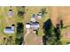 Birds eye view of the property displaying the house, sheds, pool, and surrounding landscape at 8211 Julian Rd, Dunn, NC 28334