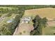 Aerial shot of the property showcasing the home, surrounding trees, and expansive land at 8211 Julian Rd, Dunn, NC 28334