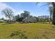 Expansive backyard, showcasing a pool, swing set, deck, and the house, perfect for outdoor activities at 8211 Julian Rd, Dunn, NC 28334