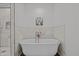 Elegant white bathtub and marble walls create a luxurious and serene bathroom at 8211 Julian Rd, Dunn, NC 28334
