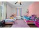 Bright bedroom featuring two beds with soft pink carpet and decor creates a cozy and inviting space at 8211 Julian Rd, Dunn, NC 28334