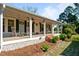 Inviting front porch with rocking chairs and swing, perfect for enjoying the outdoors at 8211 Julian Rd, Dunn, NC 28334