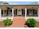 Close-up of the entrance of the house with brick steps and well-maintained landscaping at 8211 Julian Rd, Dunn, NC 28334