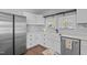 Charming kitchen boasts white cabinetry, quartz countertops, and stainless steel appliances at 8211 Julian Rd, Dunn, NC 28334