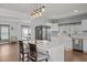 Bright kitchen featuring a large island with seating, stainless steel appliances, and modern pendant lighting at 8211 Julian Rd, Dunn, NC 28334