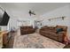 Open-concept living room with plush couches and an area rug, flowing into the dining and kitchen areas at 8211 Julian Rd, Dunn, NC 28334