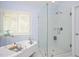 Bright bathroom showcasing a standalone tub next to a window and a glass enclosed shower at 8508 Kayenta Ct, Wake Forest, NC 27587