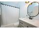 Modern bathroom features a vanity with a marble countertop and a tub-shower combo with a white curtain at 8508 Kayenta Ct, Wake Forest, NC 27587