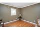 Simple bedroom featuring a hardwood floor and natural light from a single window at 8508 Kayenta Ct, Wake Forest, NC 27587